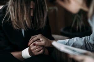 Therapist holding a woman's hand