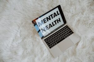 A laptop with 'mental health' on the screen